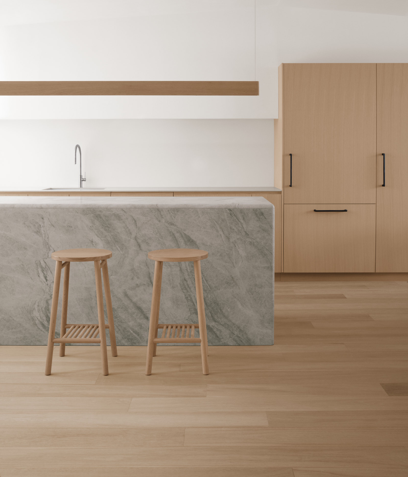 two tame high stools against marble kitchen island