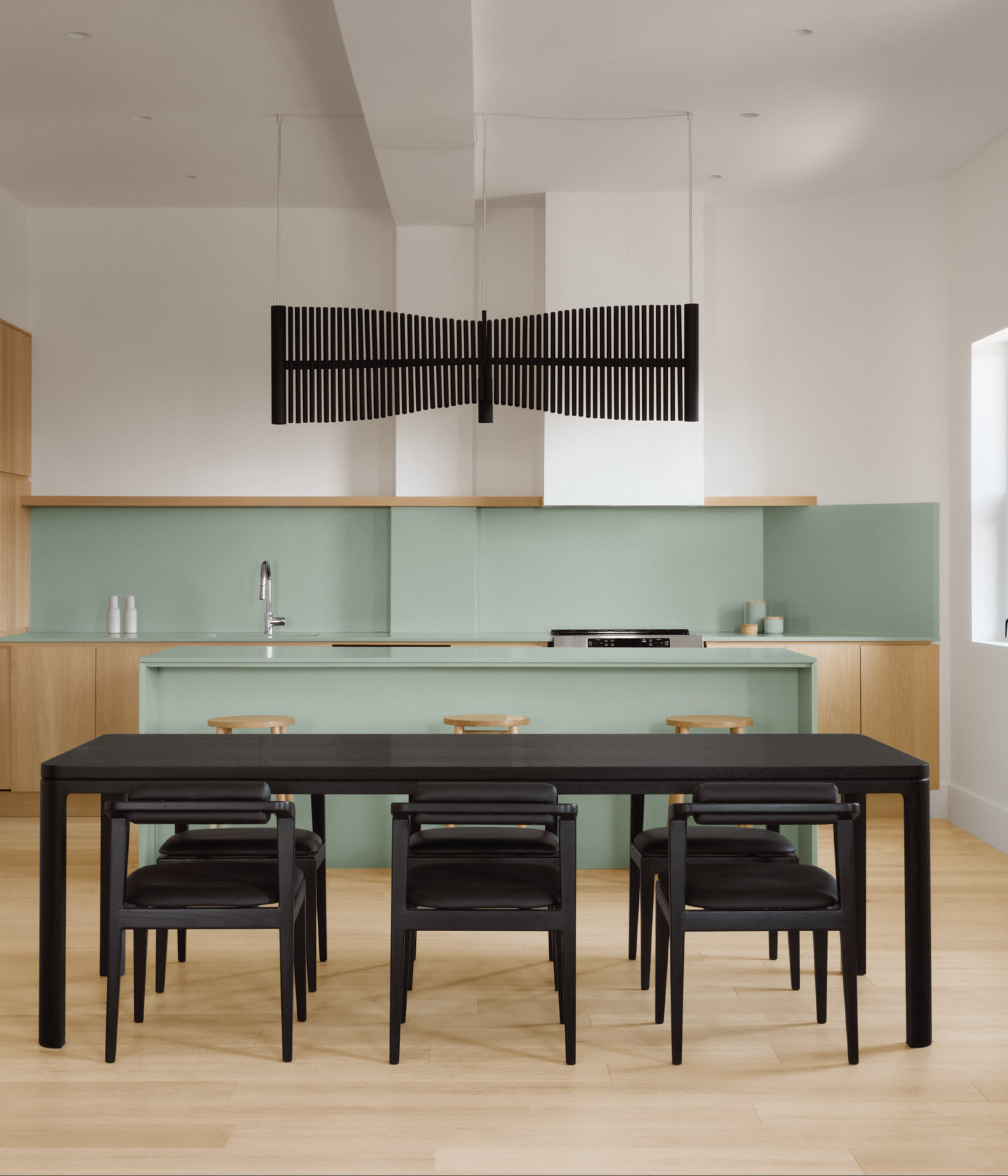 All black Nord table set in a colorful kitchen