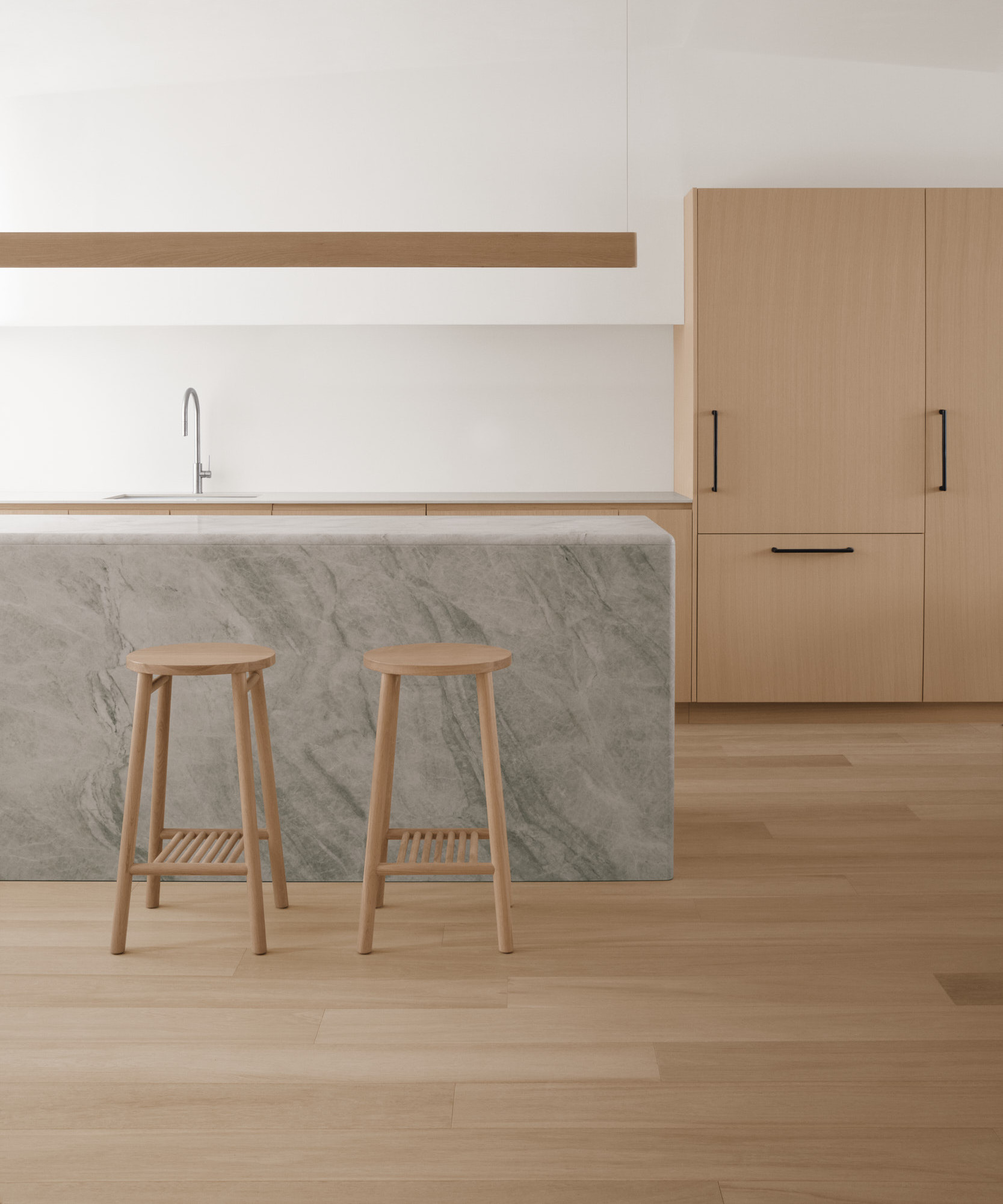 two tame high stools against marble kitchen island