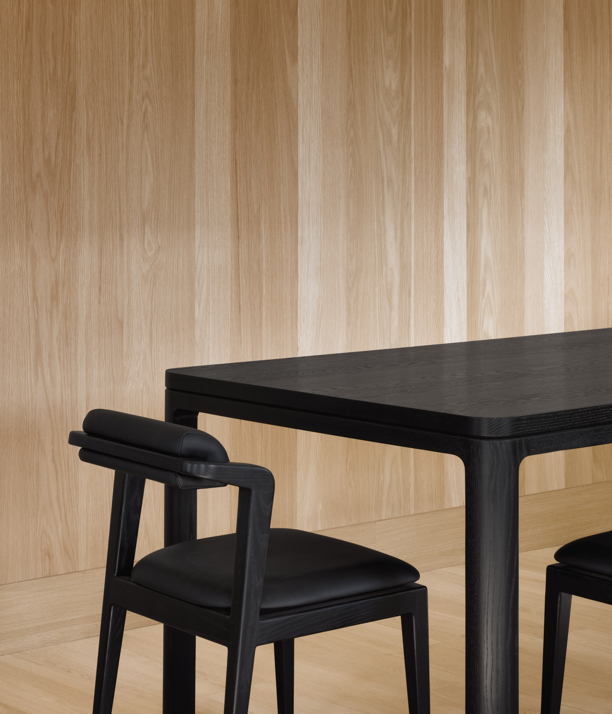 Nord chair without armrests in all black next to black Nord table