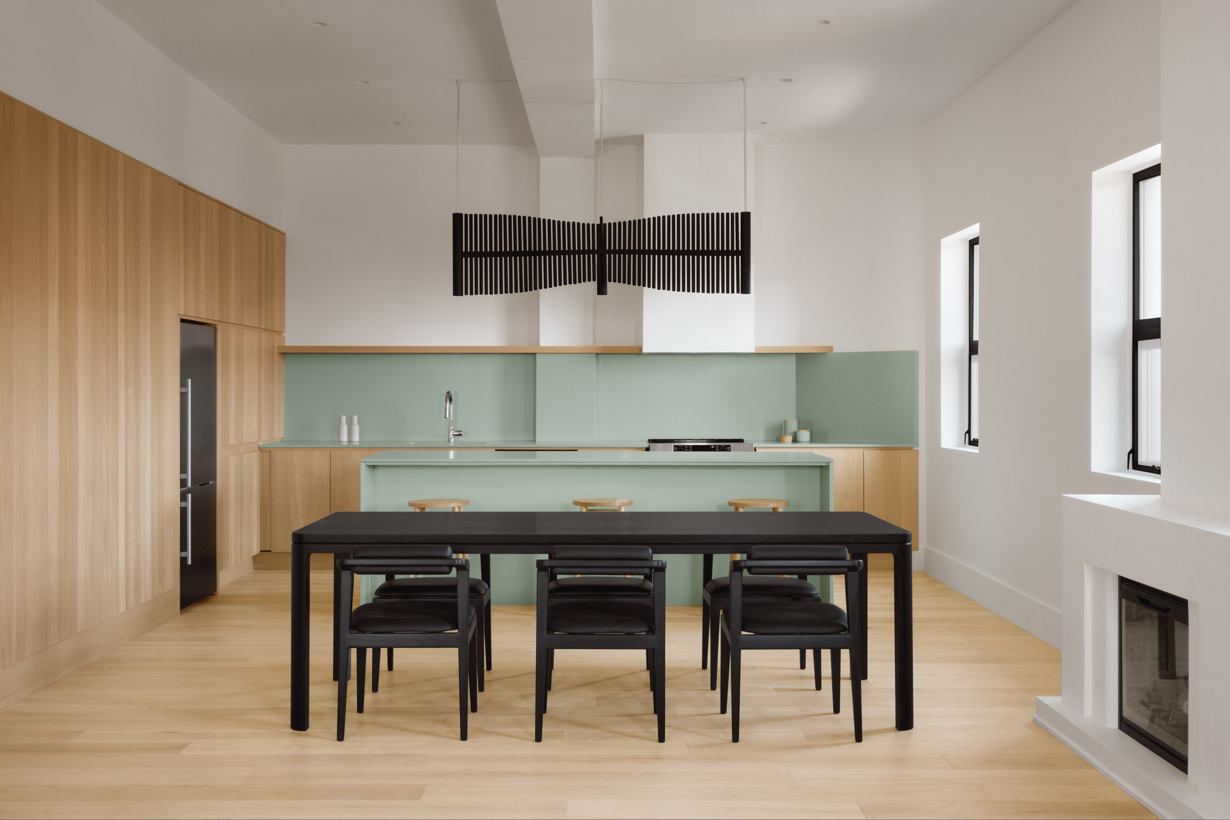 All black Nord table set in a colorful kitchen