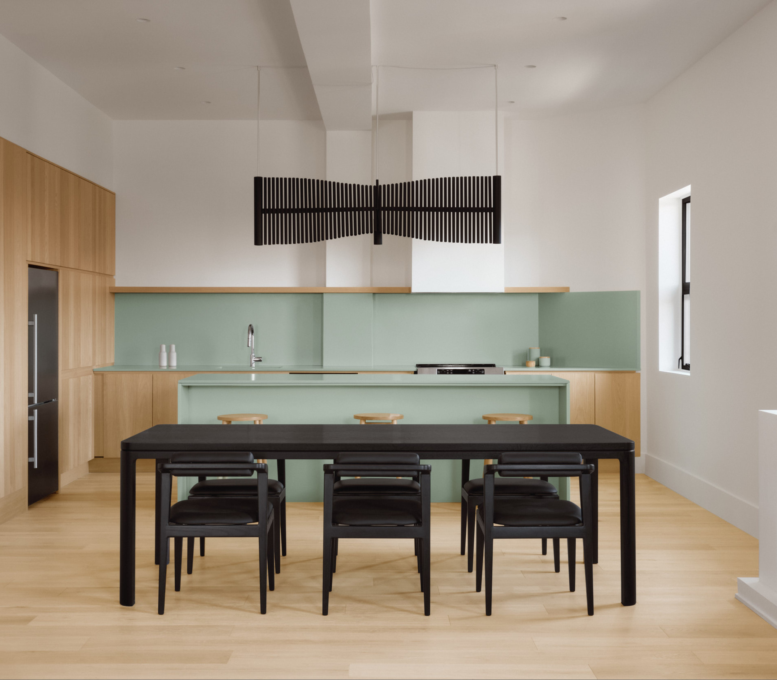 All black Nord table set in a colorful kitchen