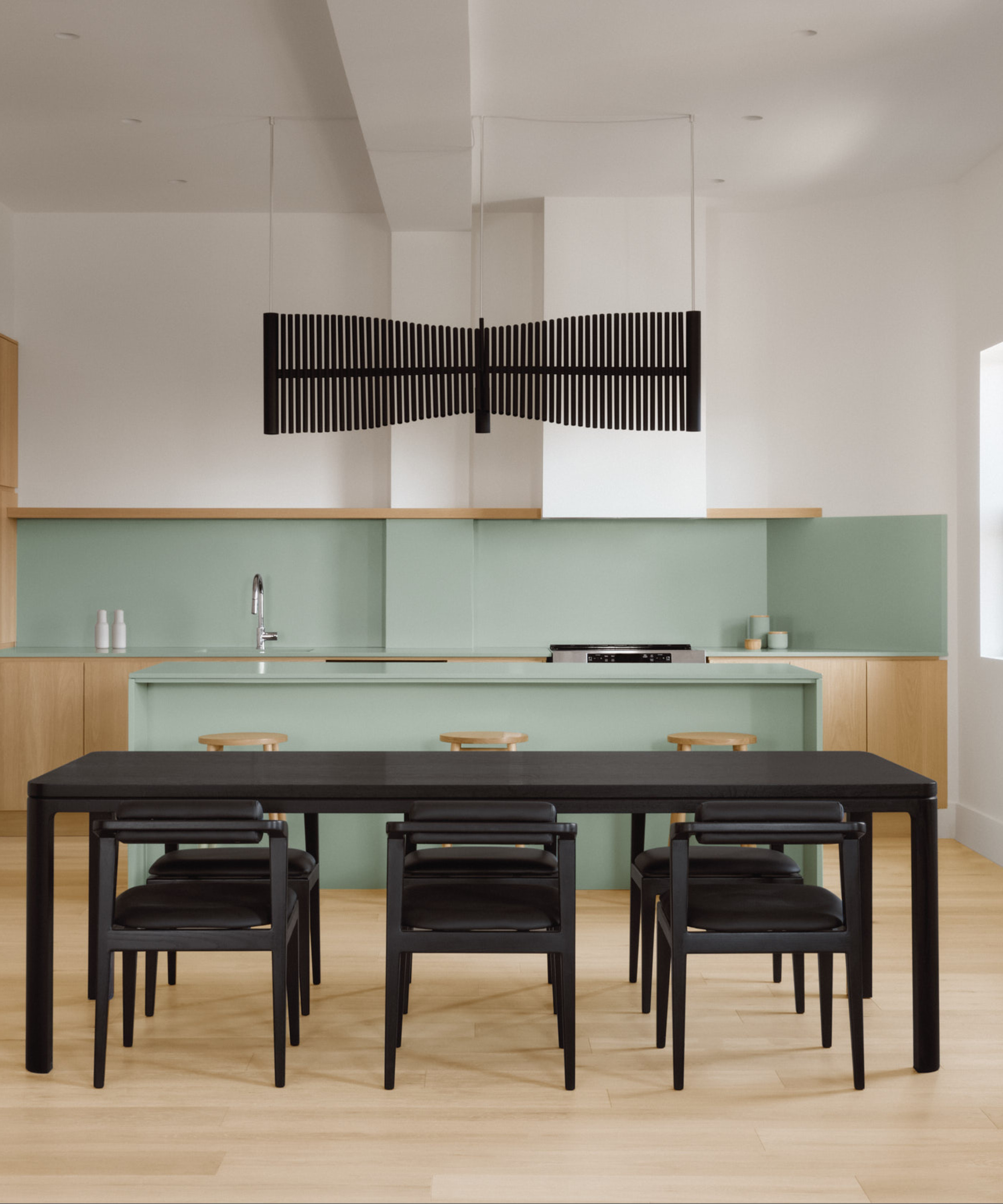 All black Nord table set in a colorful kitchen