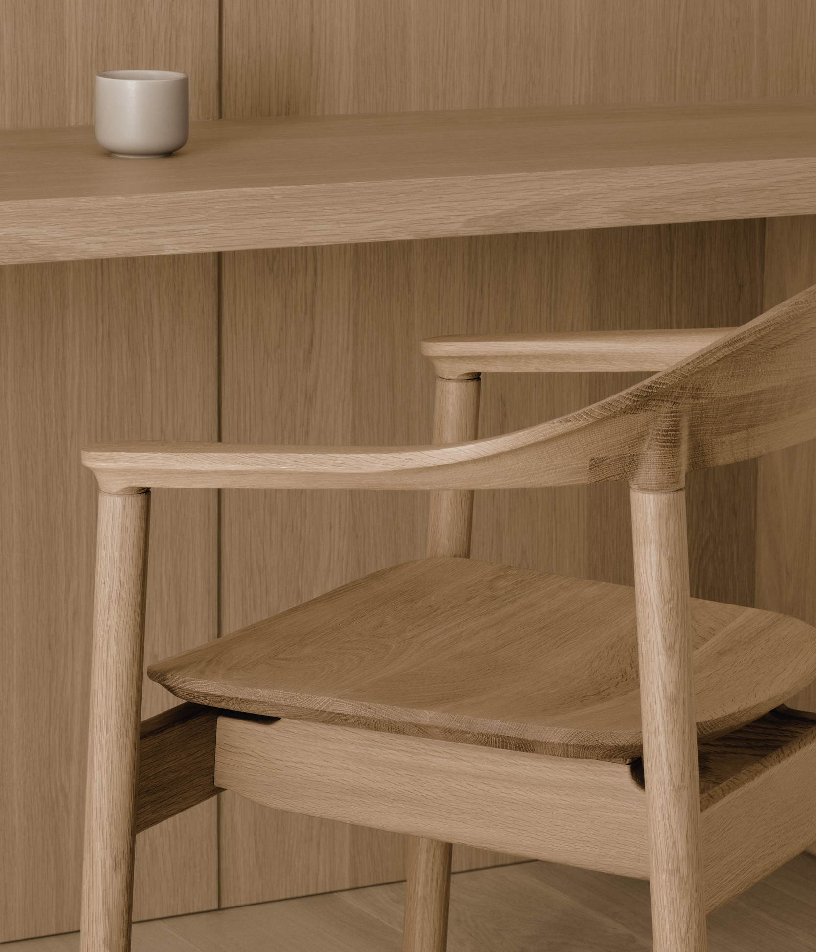 A close up of the Dune armrest in white oak