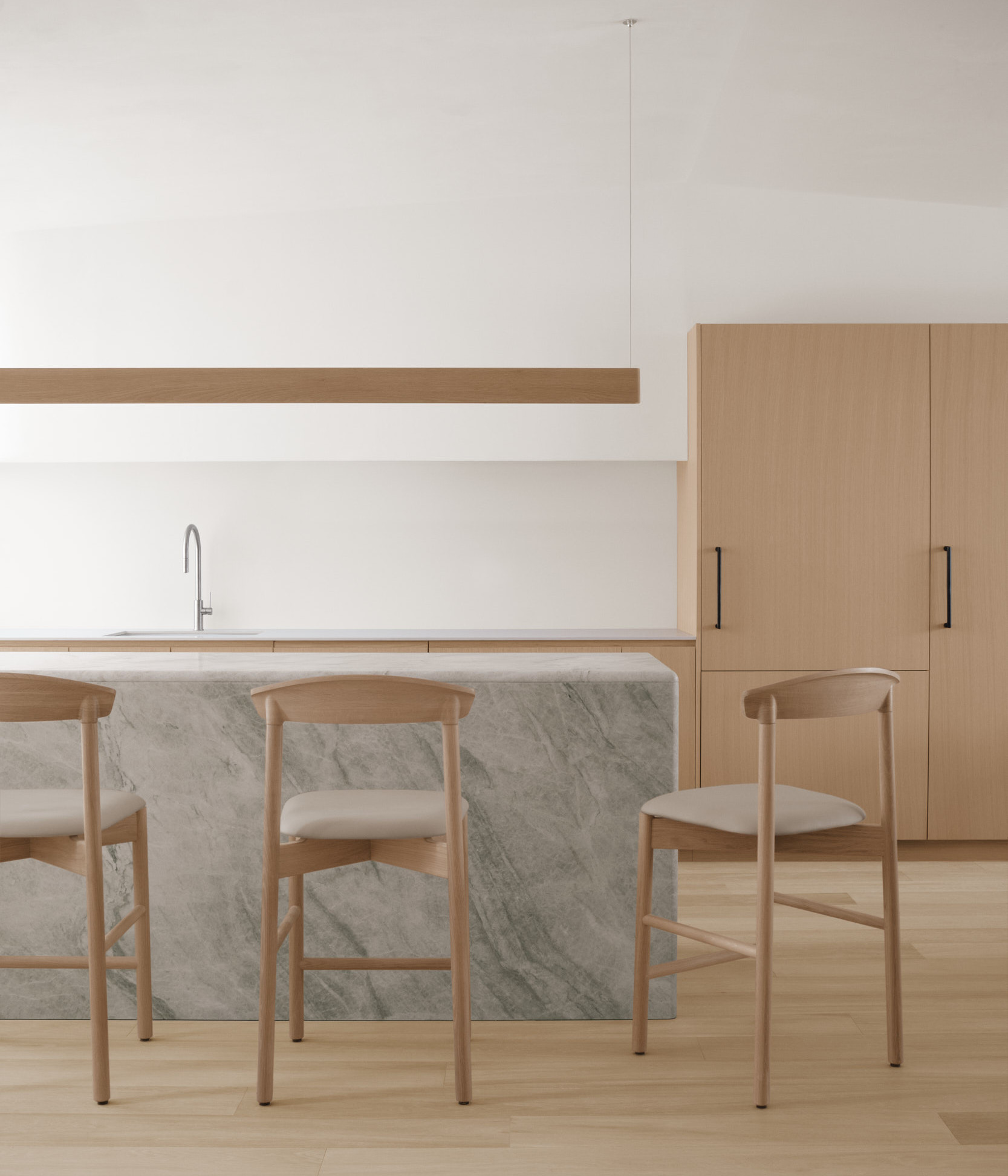 three dune stools in white oak at marble kitchen island