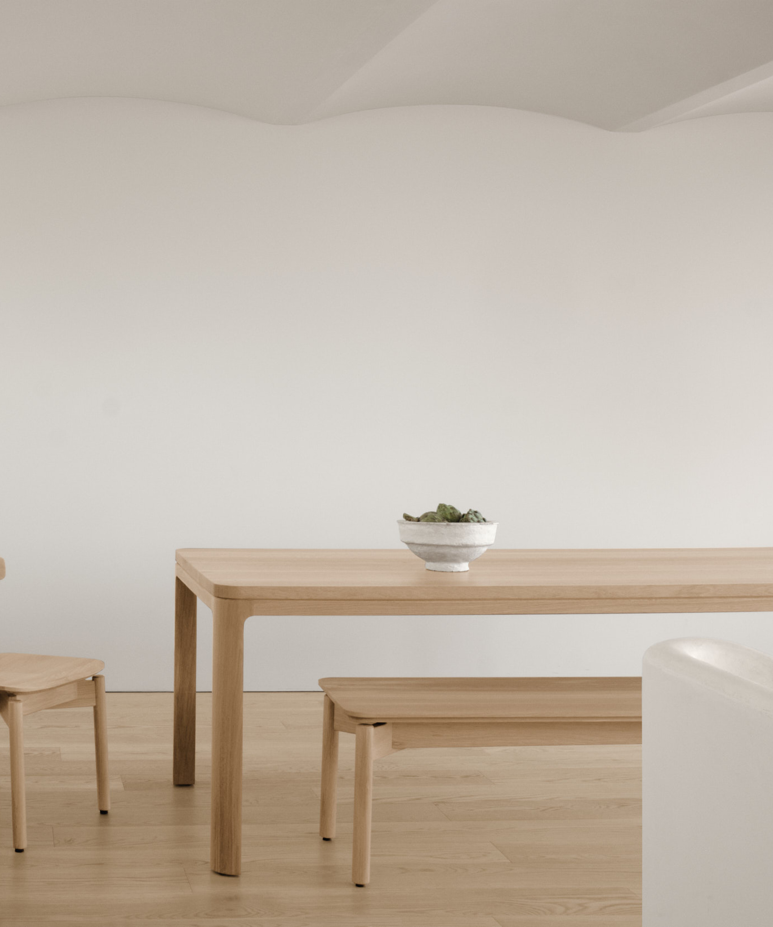 Dune bench along nord table and a dune chair in white oak