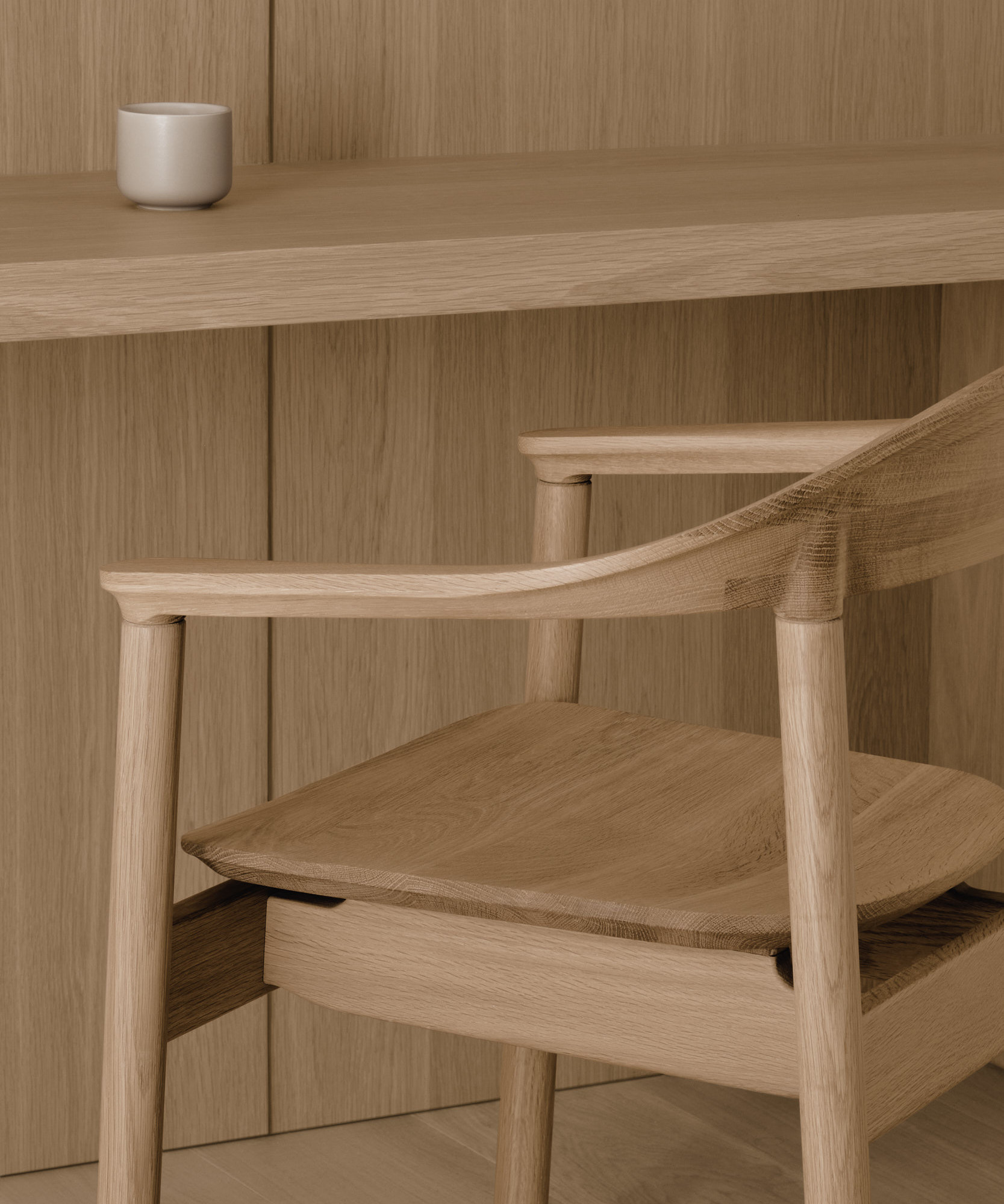 A close up of the Dune armrest in white oak