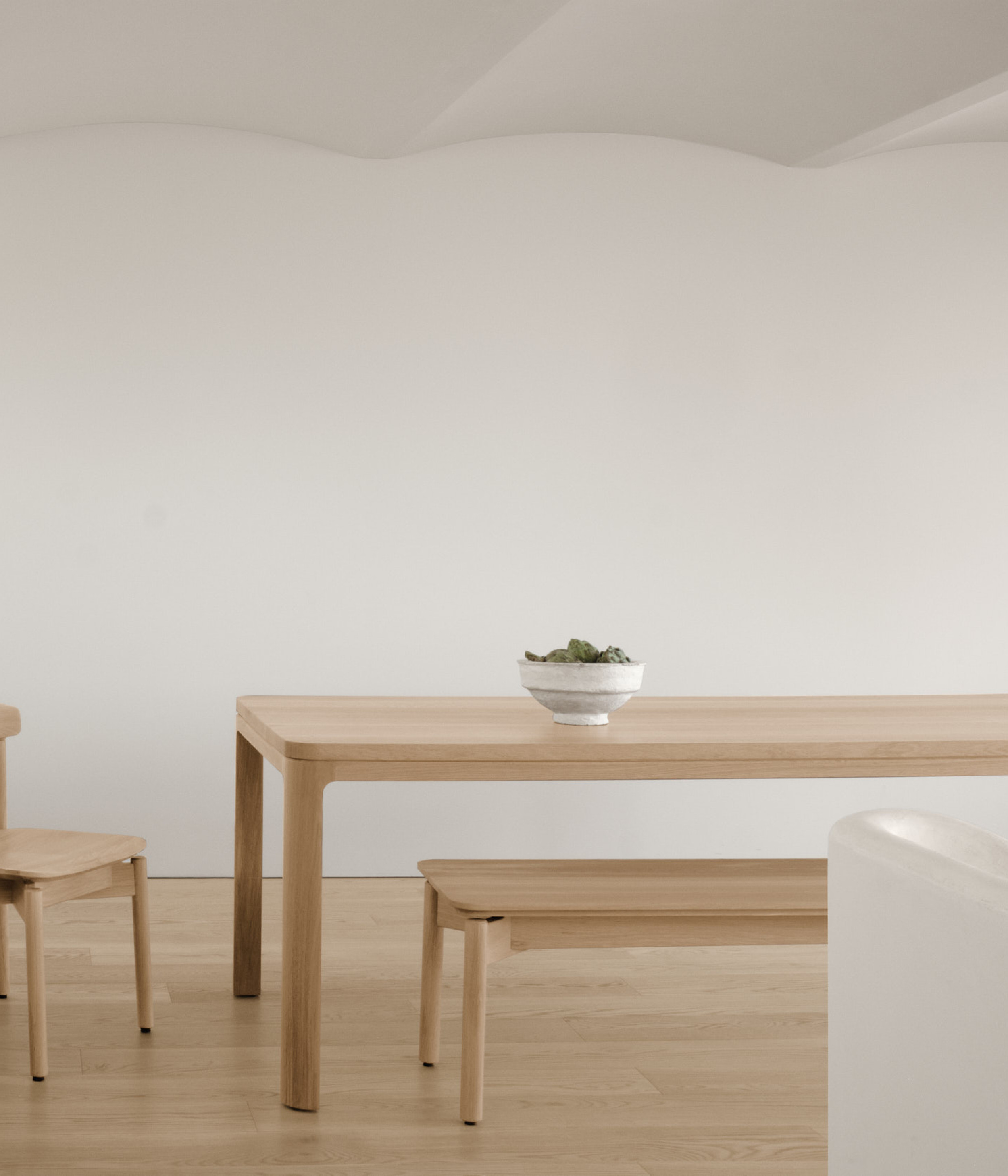 Dune bench along nord table and a dune chair in white oak