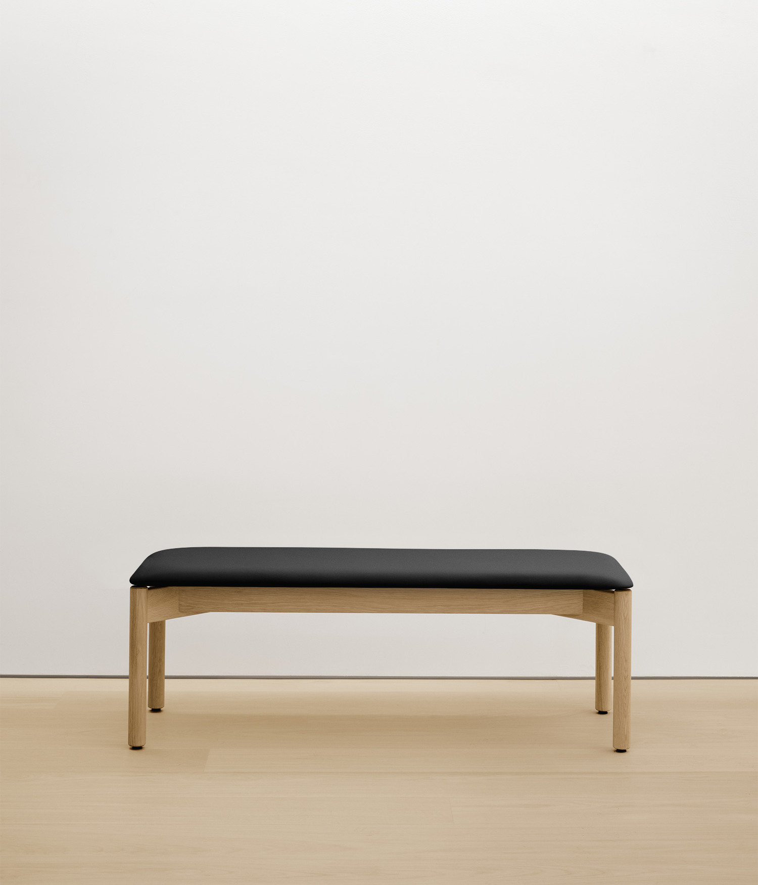 white-oak bench with black upholstered seat