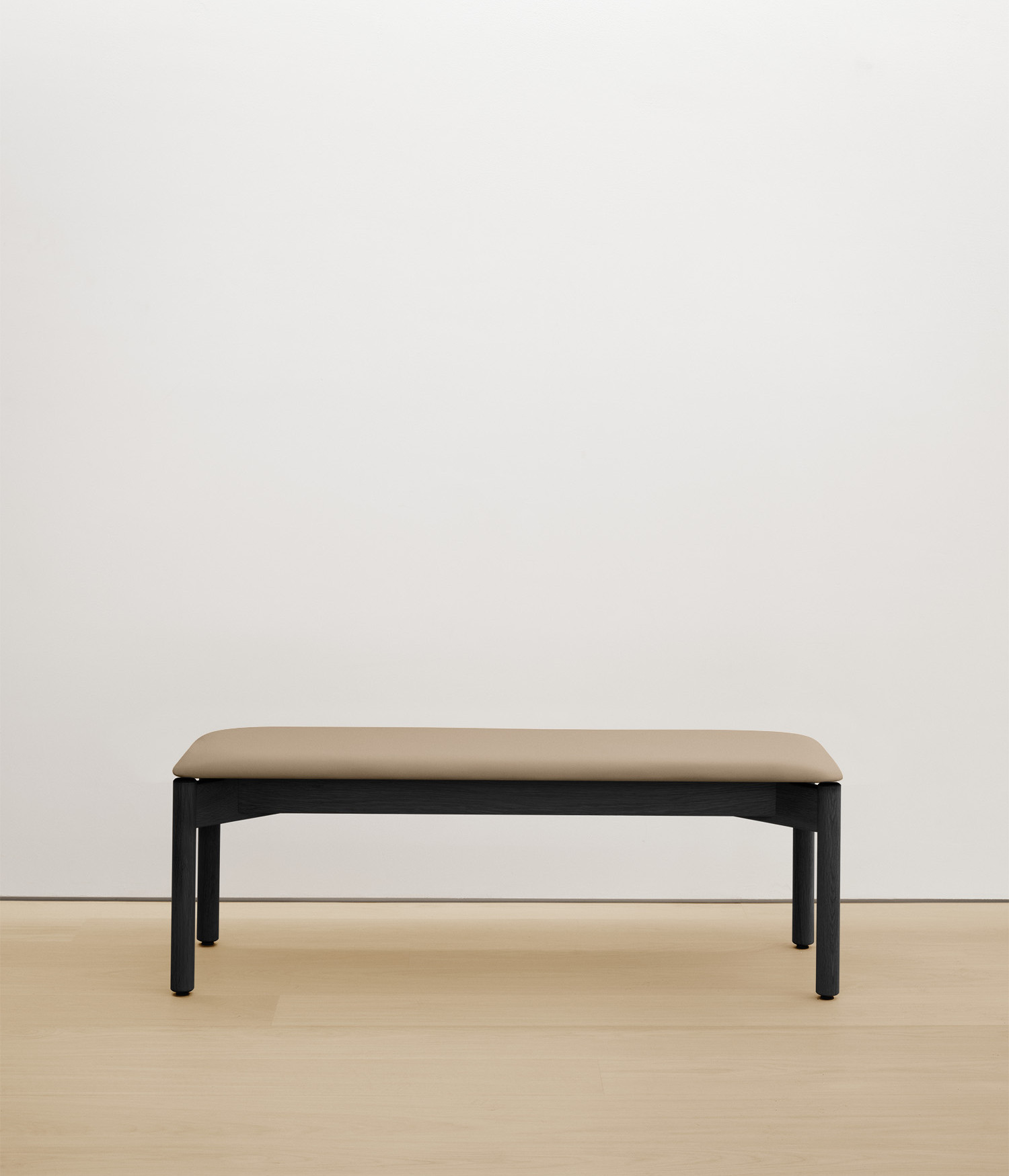 black-stained-oak bench with cream upholstered seat