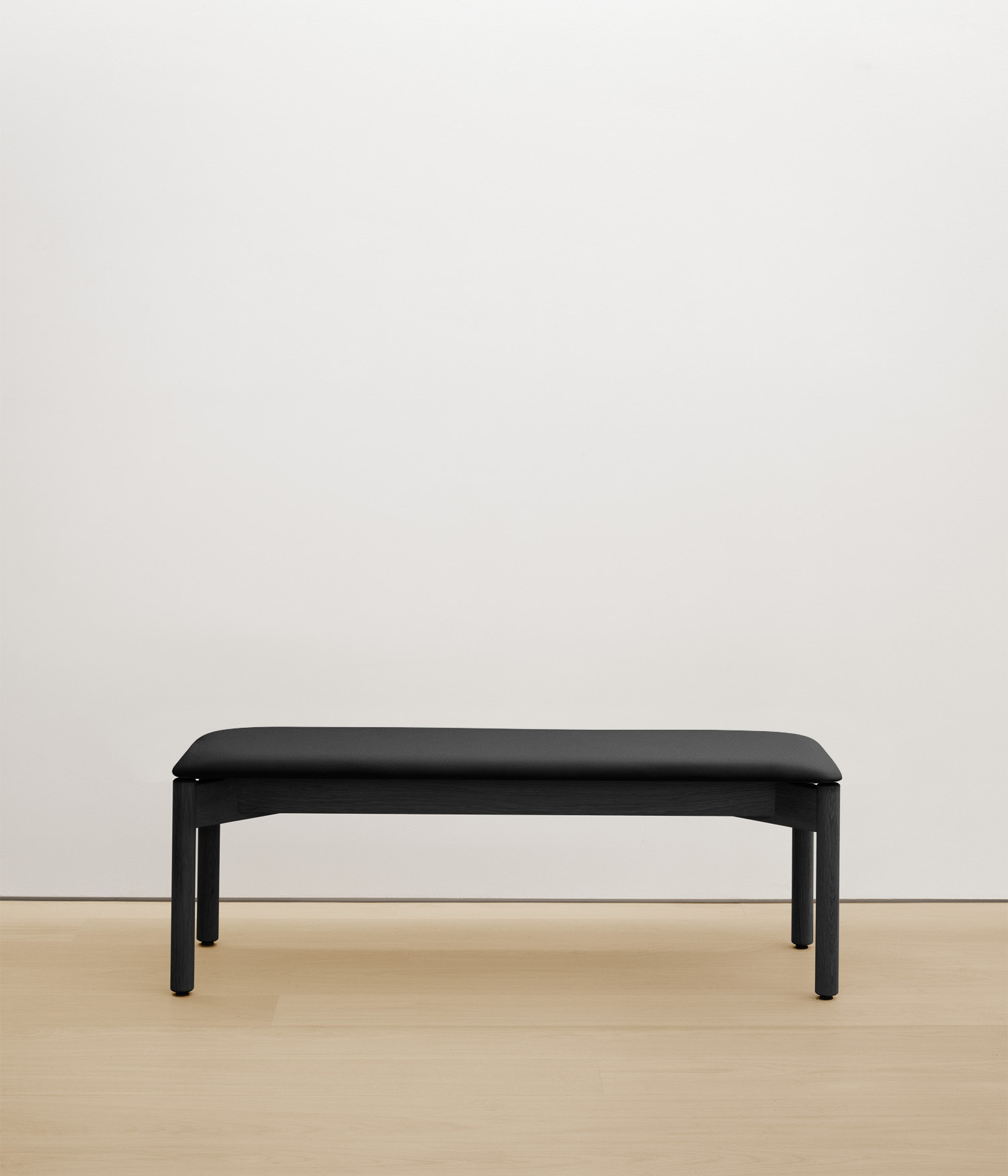 black-stained-oak bench with black upholstered seat
