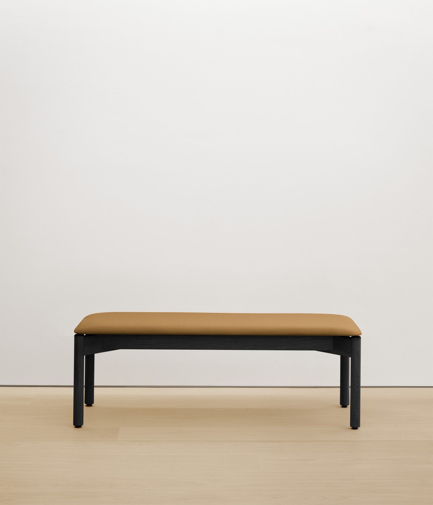 black-stained-oak bench with tan upholstered seat