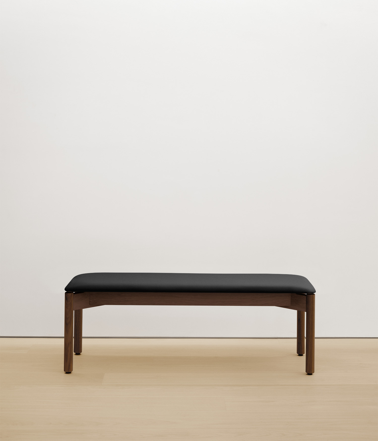 walnut bench with black upholstered seat